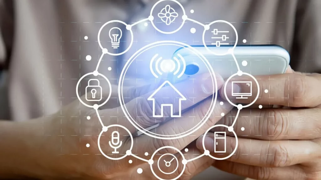 Im Vordergrund ist eine grafische Benutzeroberfläche mit verschiedenen Smart-Home-Funktionen zu sehen, darunter Beleuchtung, Klima, Sicherheit, Haushaltsgeräte, Unterhaltung und Einstellungen. Im Hintergrund hält eine Person ein Smartphone, das die intuitive Bedienung per App symbolisiert. Das Motiv steht für eine zentrale, vernetzte Smart-Home-Steuerung, mit der alle wichtigen Funktionen des Hauses einfach, übersichtlich und von überall aus kontrolliert werden können.